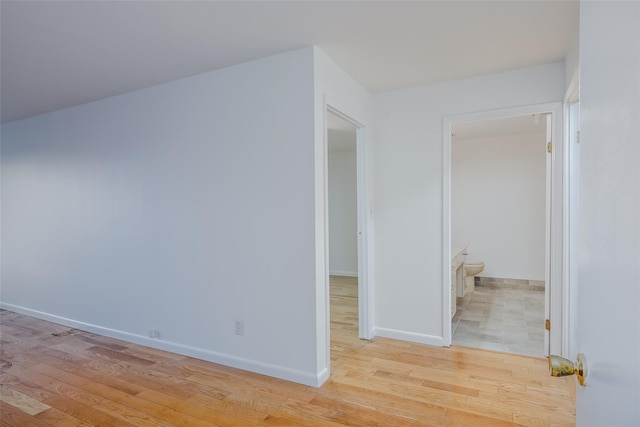 empty room featuring light wood-style floors and baseboards