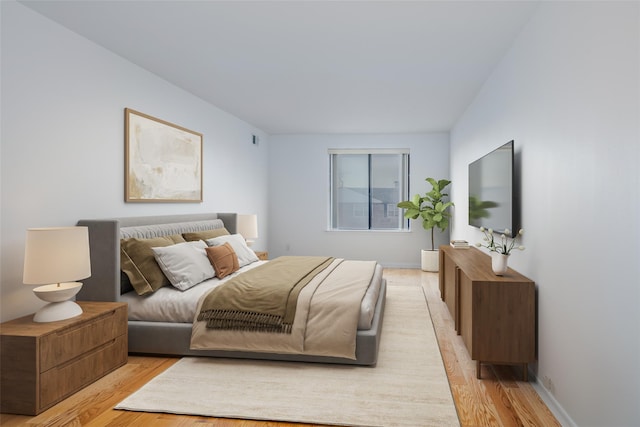 bedroom with light wood-style flooring and baseboards