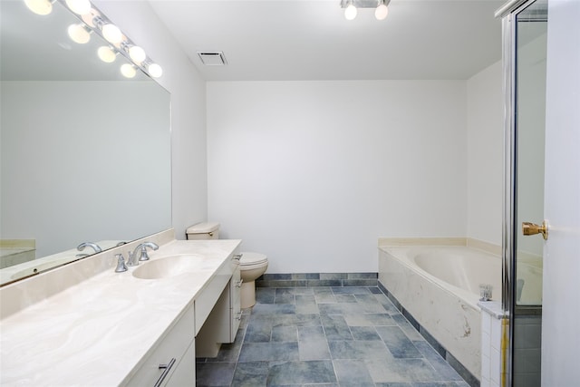 bathroom with a garden tub, toilet, vanity, visible vents, and baseboards