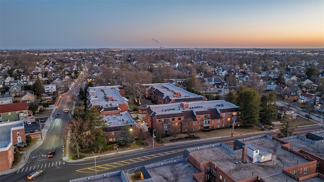 aerial view at dusk featuring a residential view