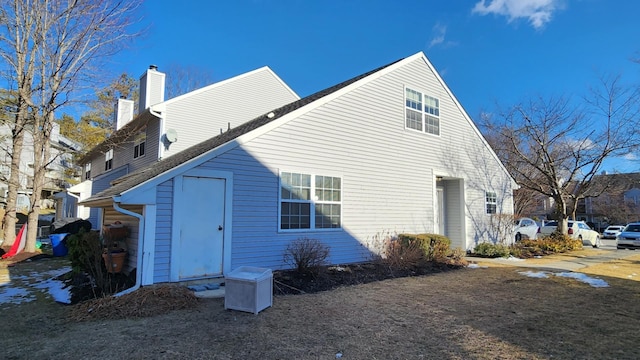 view of side of home featuring a chimney