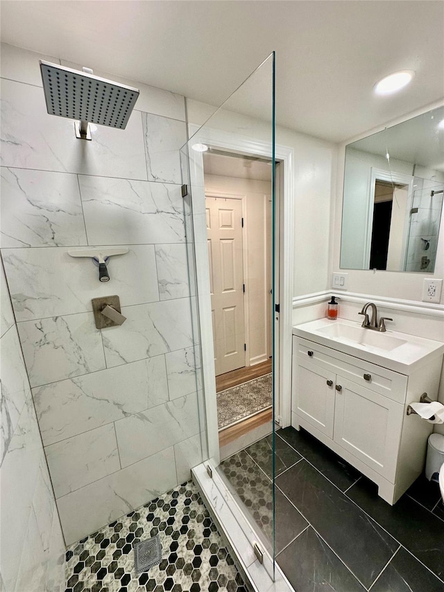 full bathroom with recessed lighting, a shower stall, and vanity