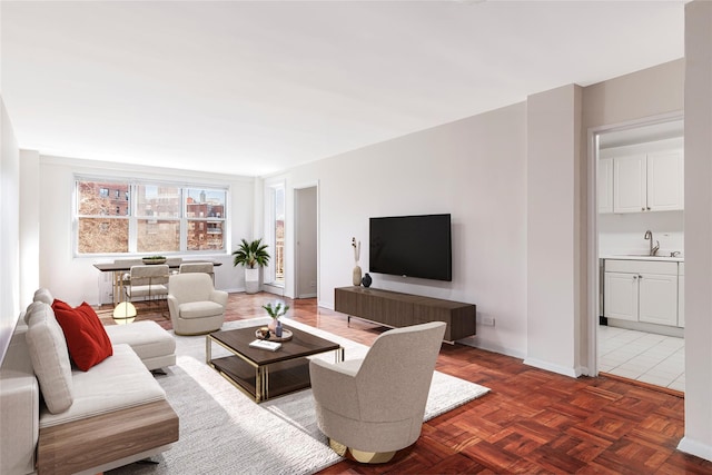 living area featuring baseboards