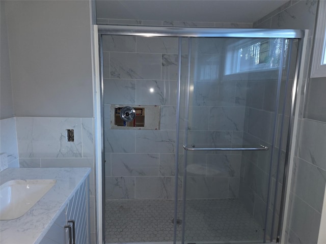 full bath featuring a stall shower and vanity