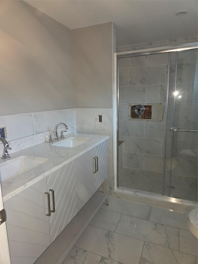 full bathroom featuring a shower stall, marble finish floor, and a sink