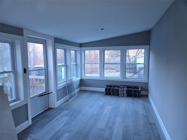 unfurnished sunroom featuring vaulted ceiling