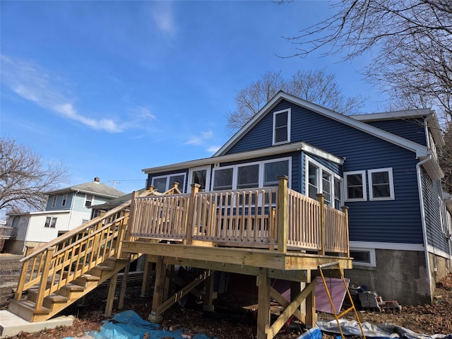 back of property with stairs and a deck