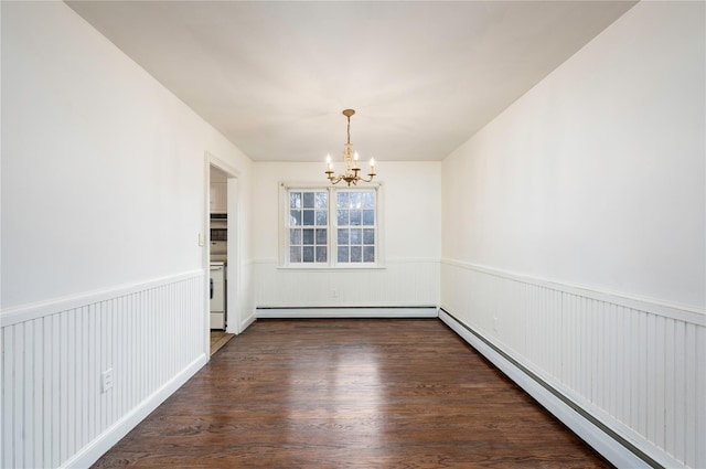 unfurnished dining area featuring a chandelier, wainscoting, dark wood-type flooring, and a baseboard radiator