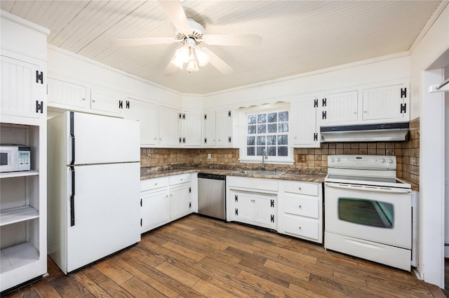 kitchen featuring white appliances, white cabinets, dark wood-type flooring, under cabinet range hood, and a sink