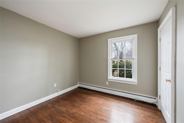 unfurnished bedroom featuring a baseboard radiator, baseboards, and dark wood finished floors