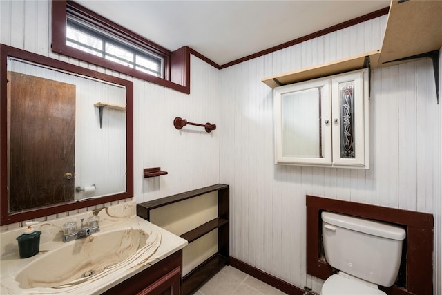 bathroom with baseboards, vanity, and toilet