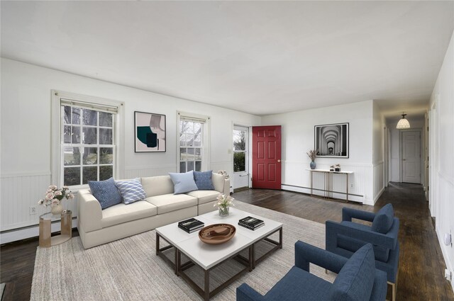 living room featuring wood finished floors, a wainscoted wall, and a baseboard radiator