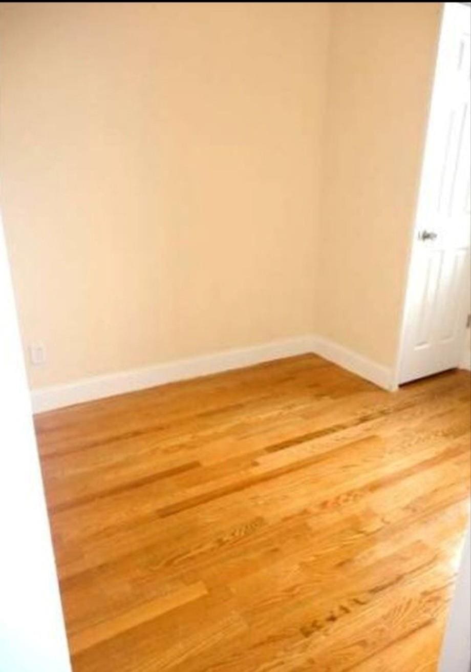 unfurnished room with light wood-style floors and baseboards