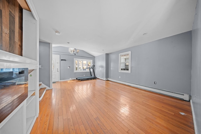 unfurnished living room featuring a chandelier, baseboard heating, light wood-type flooring, and lofted ceiling