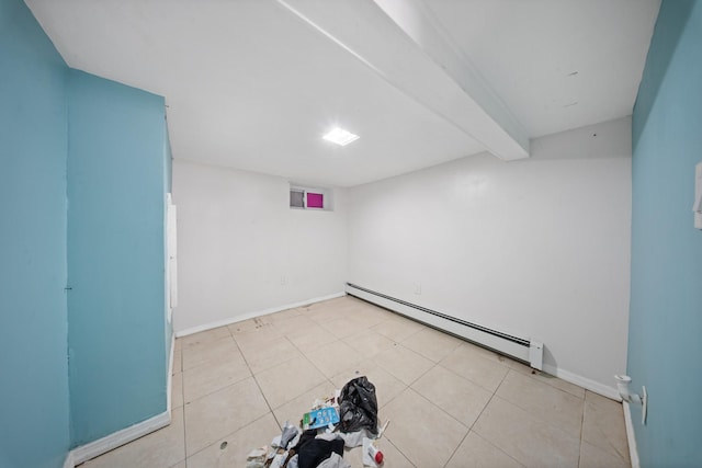 spare room featuring light tile patterned floors, baseboards, baseboard heating, and beam ceiling