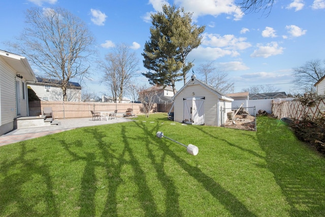 view of yard with a fenced backyard, a shed, a patio, and an outdoor structure