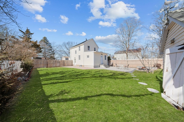 view of yard featuring entry steps, a fenced backyard, and a patio