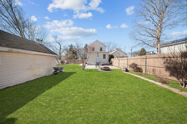 view of yard featuring a fenced backyard, a fire pit, and a patio