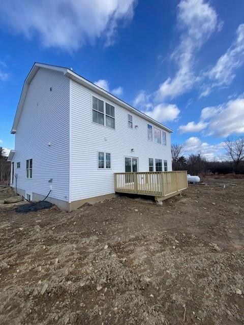 back of house featuring a wooden deck