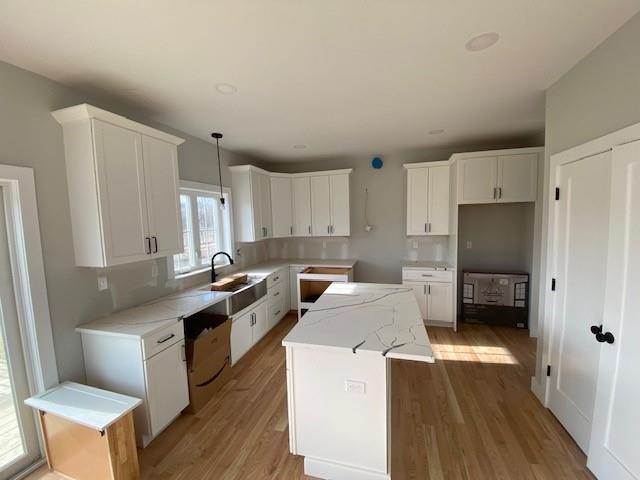 kitchen featuring light wood-style floors, white cabinets, and a kitchen island