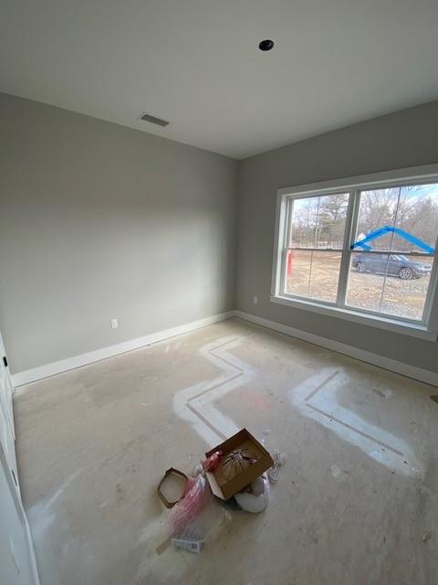 unfurnished room featuring visible vents and baseboards