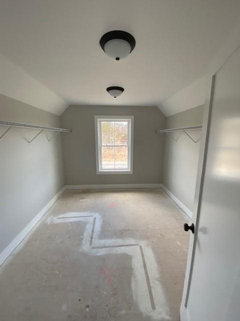 walk in closet with lofted ceiling