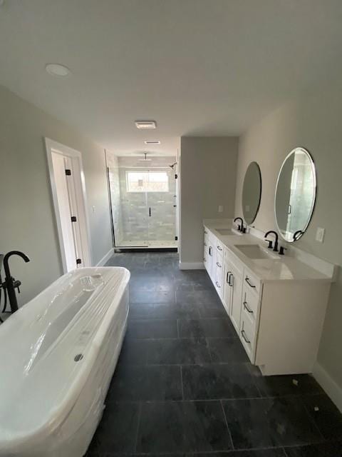 bathroom with double vanity, a stall shower, a sink, and a soaking tub