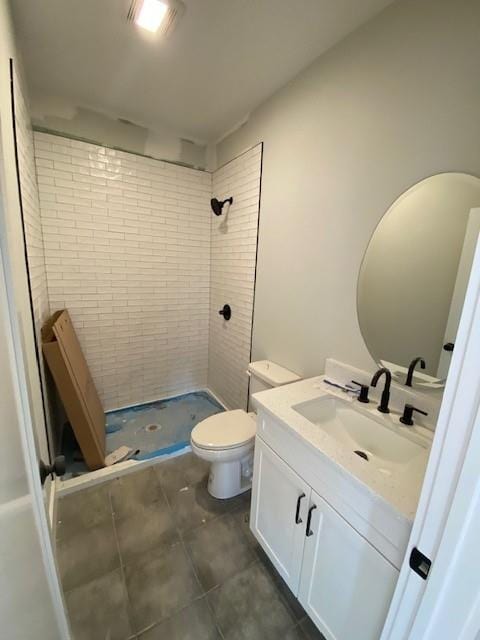 bathroom with toilet, a stall shower, vanity, and tile patterned floors