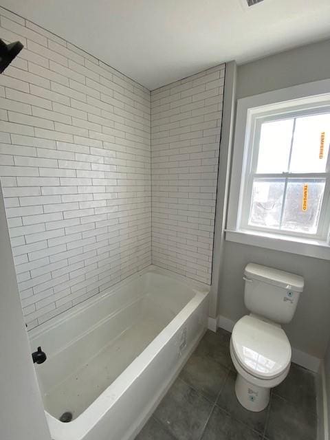 bathroom with toilet, shower / bath combination, tile patterned flooring, and baseboards