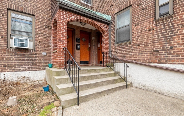 property entrance featuring brick siding