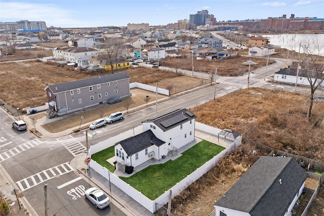 birds eye view of property featuring a water view and a city view