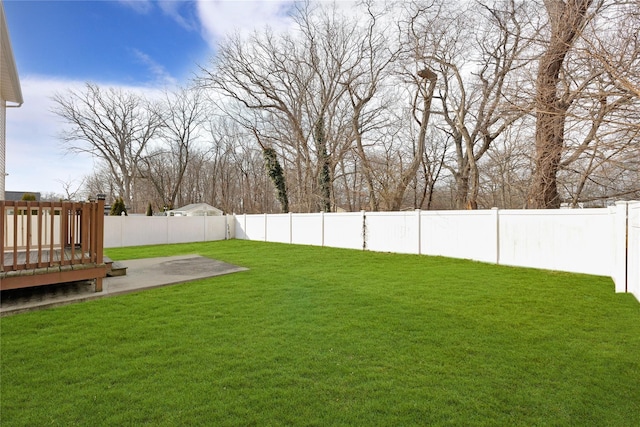 view of yard featuring a fenced backyard and a deck