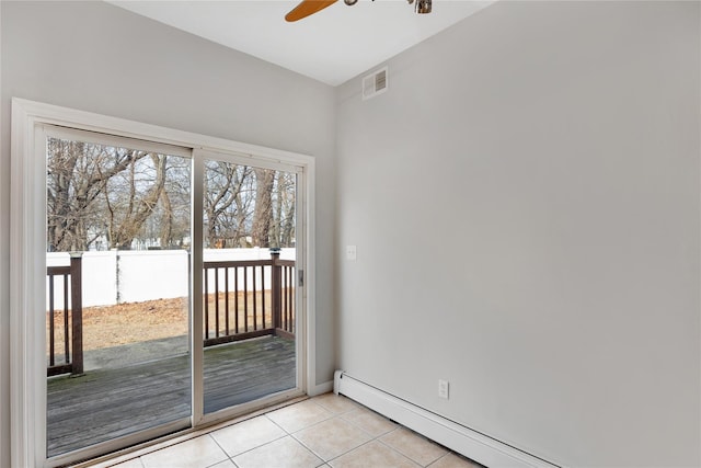 entryway featuring light tile patterned floors, baseboards, visible vents, a ceiling fan, and a baseboard heating unit