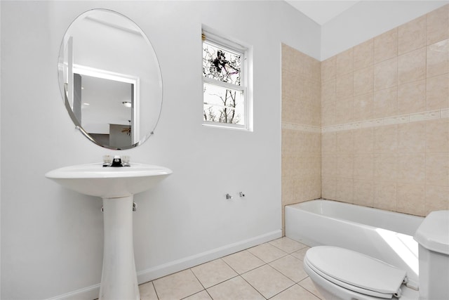 bathroom with toilet, tile patterned flooring, and baseboards