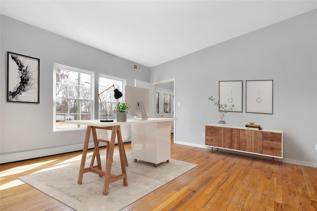 dining area with visible vents, light wood-style flooring, and baseboards