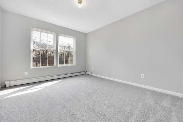 carpeted spare room with baseboards and a baseboard heating unit