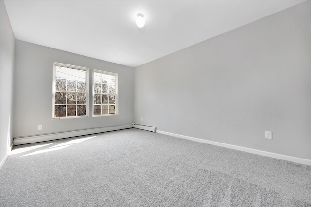 carpeted spare room with a baseboard heating unit and baseboards