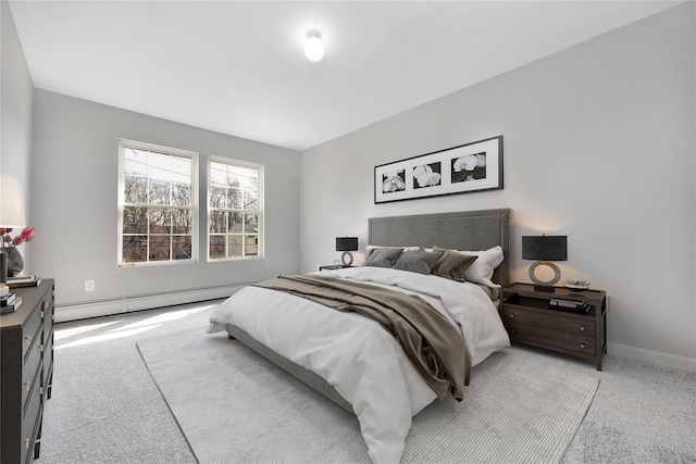 carpeted bedroom with baseboards and a baseboard heating unit