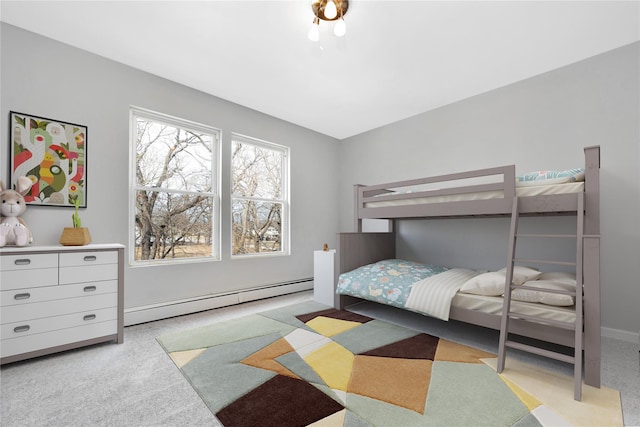 bedroom with a baseboard radiator and light colored carpet