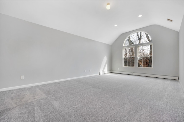 interior space with lofted ceiling, a baseboard heating unit, carpet floors, visible vents, and baseboards