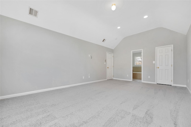 interior space featuring recessed lighting, light colored carpet, visible vents, baseboards, and vaulted ceiling