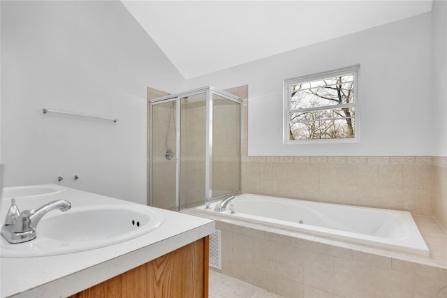 full bath with a garden tub, a stall shower, vaulted ceiling, a sink, and tile patterned flooring