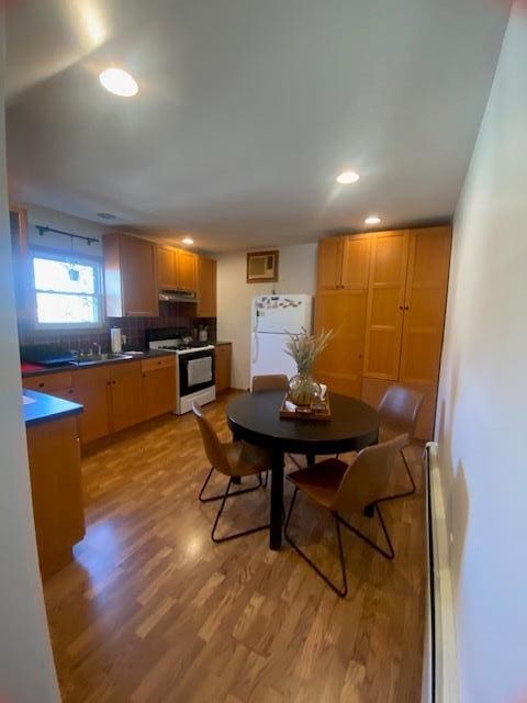 dining space with recessed lighting and light wood-style floors