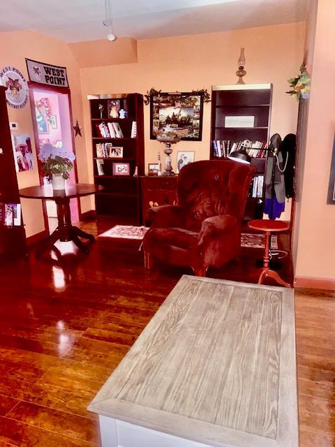 living area featuring baseboards and wood finished floors