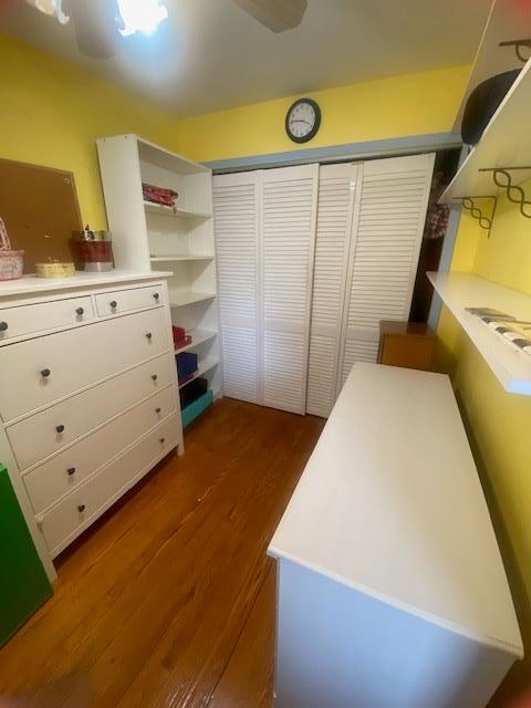 interior space with ceiling fan, a closet, and dark wood-style floors