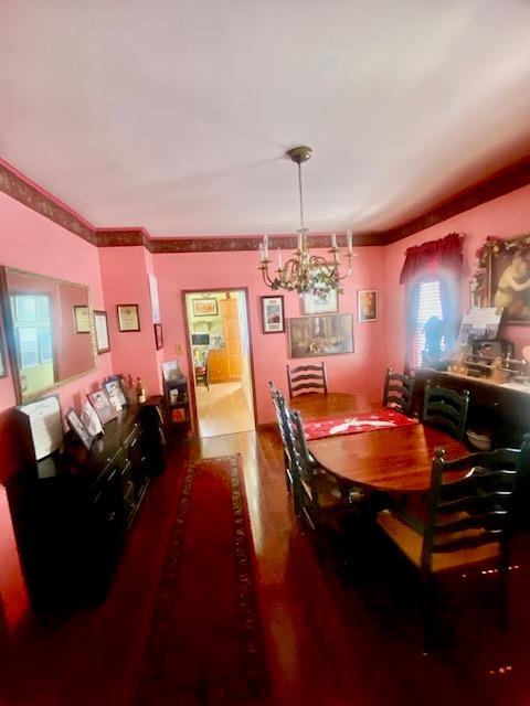 dining area with an inviting chandelier and wood finished floors