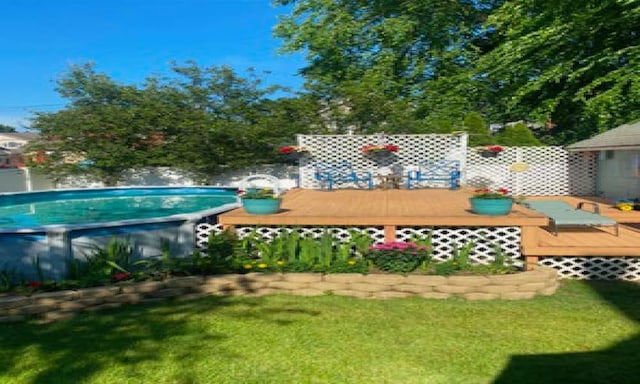 view of yard featuring an outdoor pool and a deck