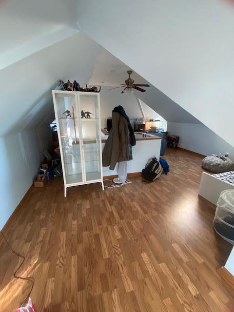 bonus room with lofted ceiling, wood finished floors, and a ceiling fan