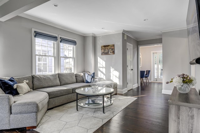 living room with plenty of natural light, wood finished floors, baseboards, and ornamental molding