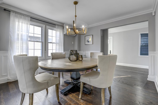 dining area featuring wainscoting, ornamental molding, dark wood finished floors, and a decorative wall